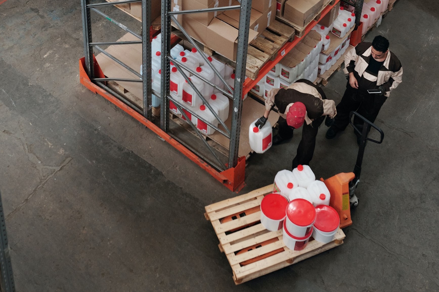 Two men putting product onto a pallet.