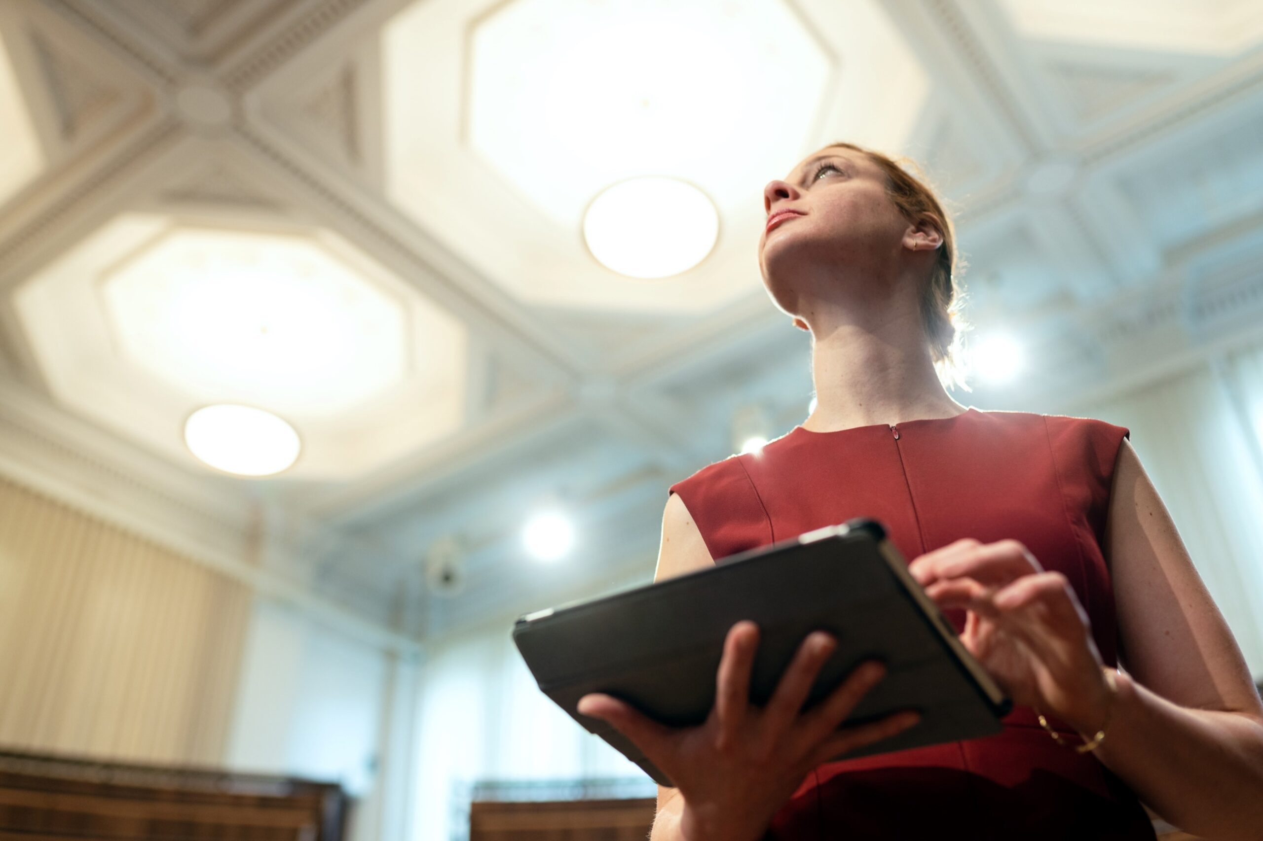 A woman holding a tablet.