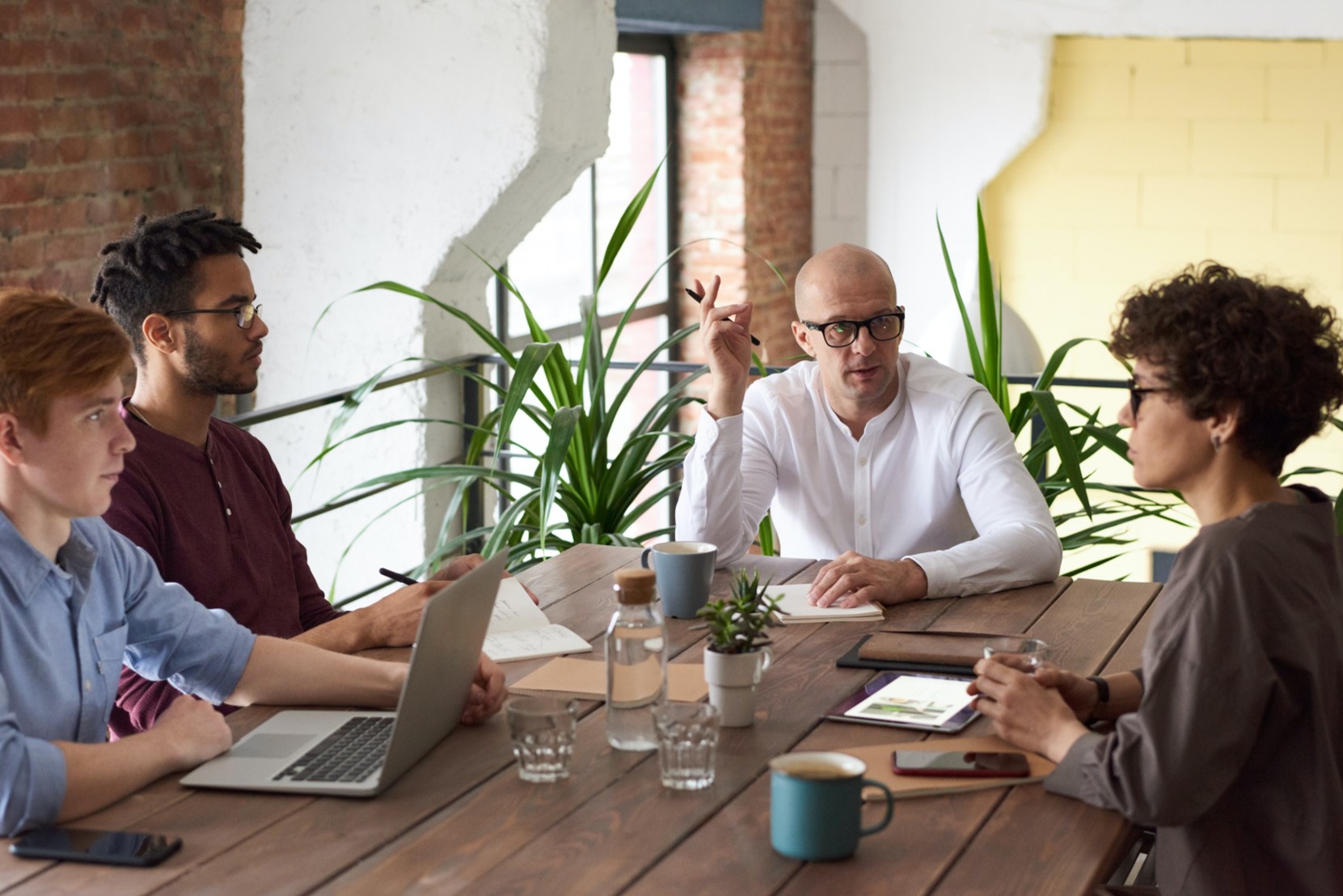 A team of people sitting around a table working.