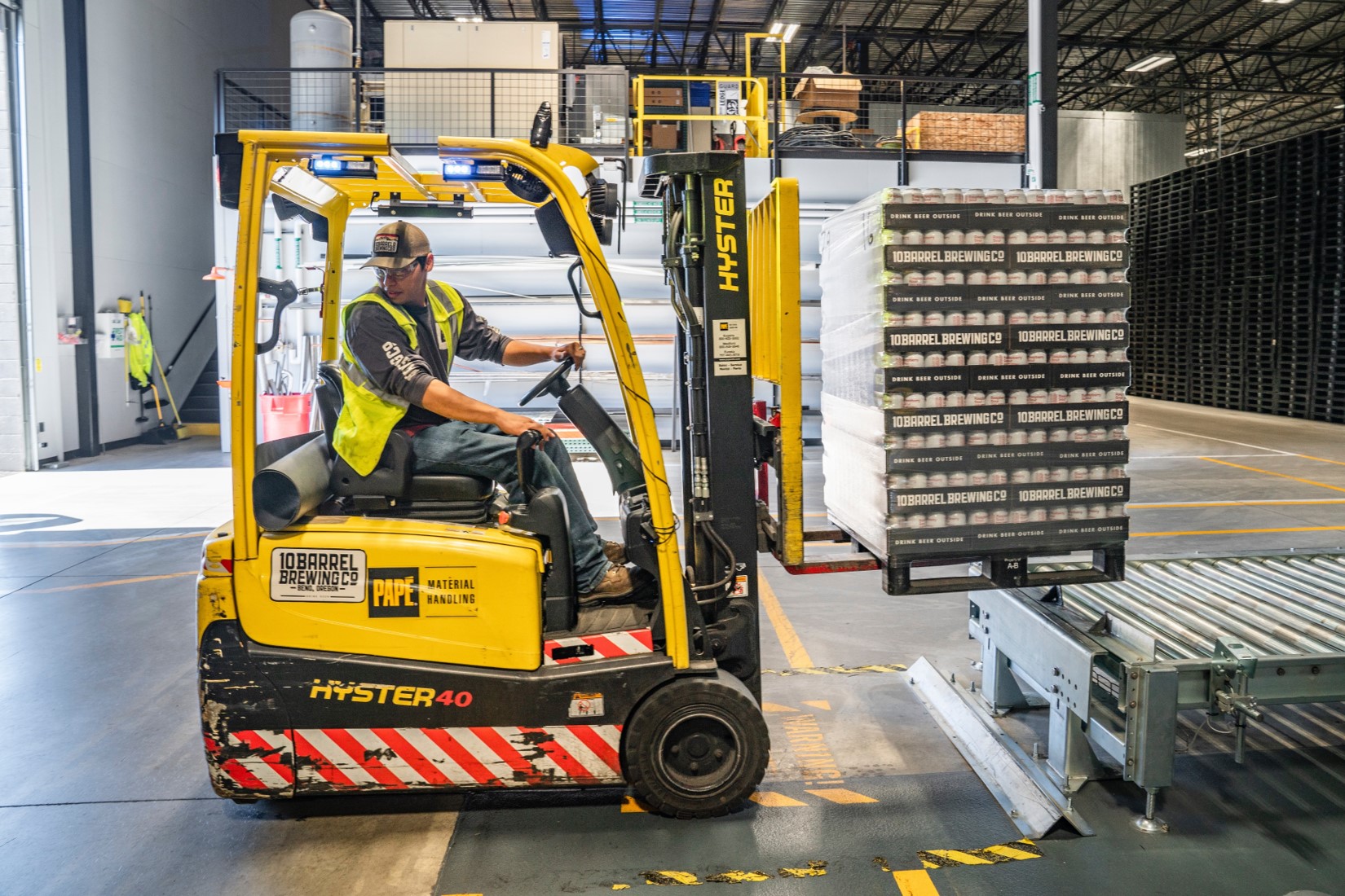 A man operating a forklift in a warehouse.